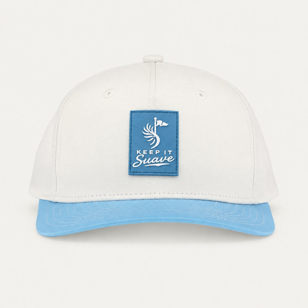 Keep It Suave snapback with cream crown, baby-blue brim, and blue logo patch, front view.
