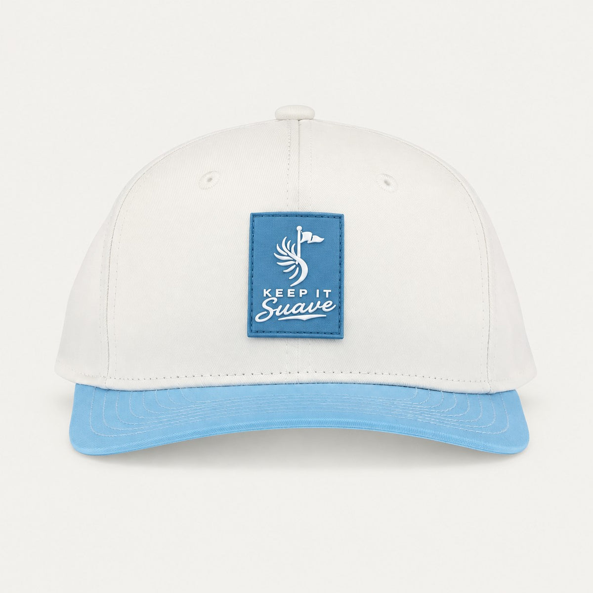 Keep It Suave snapback with cream crown, baby-blue brim, and blue logo patch, front view.