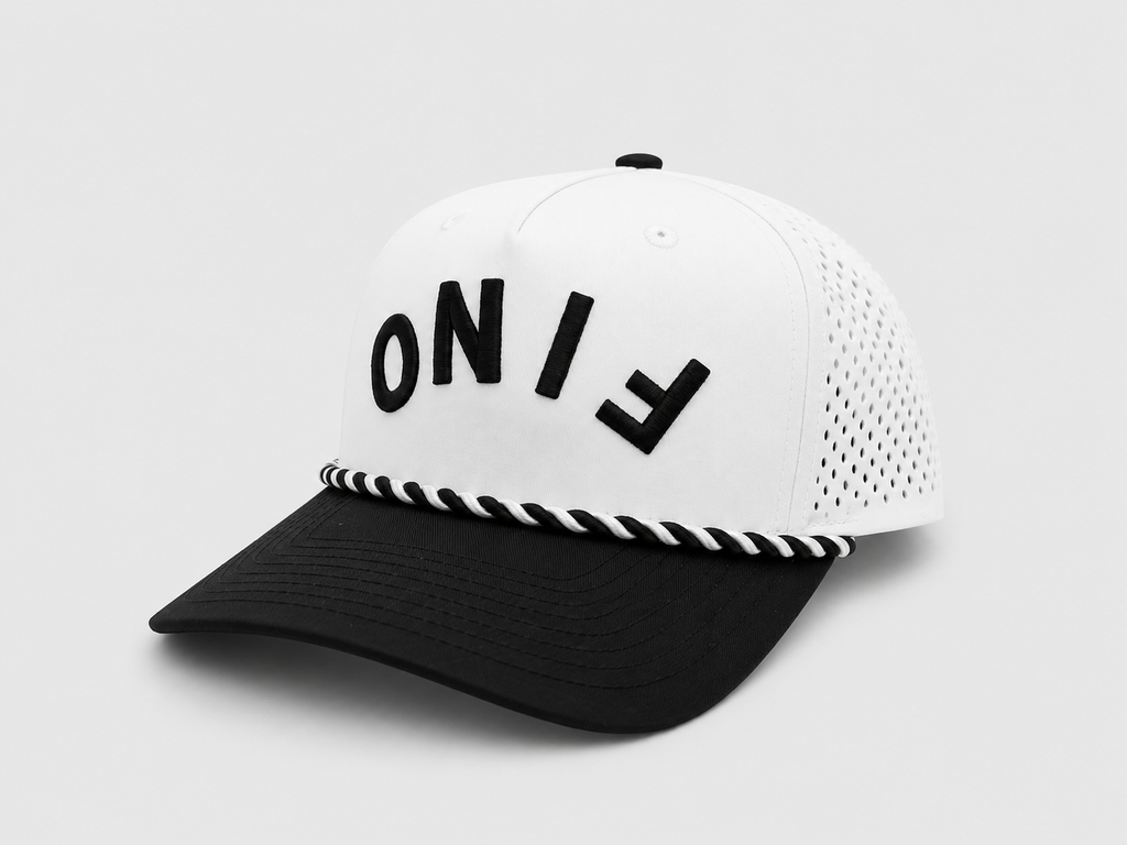 Three-quarter view of the white and black Fino cap with upside-down lettering and perforated side panels.